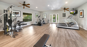 Tustin apartment for rent - Modern gym with large windows, mirrors, and updated equipment