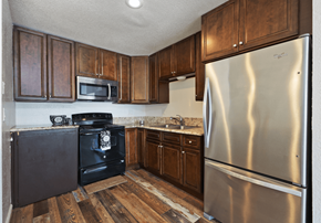 Loma Linda apartment for rent - a kitchen with stainless steel appliances and wooden cabinets