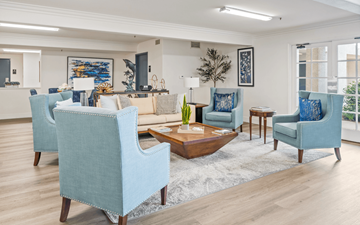 Garden Grove apartment for rent - A living room with blue chairs and a wooden coffee table.