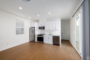 Fontana apartment for rent - A modern kitchen with white cabinets and stainless steel appliances.