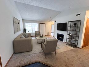 Fairlawn apartment for rent - A living room with a fireplace and a television.