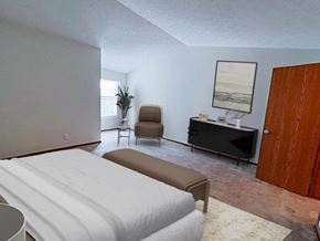 Fairlawn apartment for rent - A bedroom with a bed, chair, and cabinet.