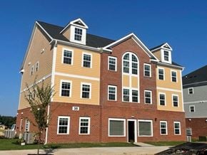 Clayton apartment for rent - a large apartment building with red brick and yellow siding