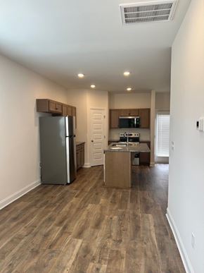 Clayton apartment for rent - A kitchen with a refrigerator, microwave, and oven.