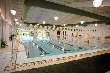 Clayton apartment for rent - a large indoor swimming pool with people in it