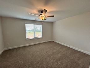 Clayton apartment for rent - A room with a ceiling fan and a window.