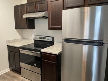 Clayton apartment for rent - a kitchen with stainless steel appliances and granite counter tops