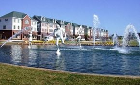 Clayton apartment for rent - a fountain in the middle of a lake with houses in the background