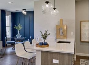Brewster apartment for rent - a kitchen with a white counter top next to a dining room