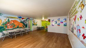 Houston apartment for rent - a dining room with a large mural on the wall and tables and chairs