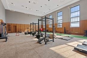 Jackson apartment for rent - A gym with a variety of equipment including weightlifting machines and a green mat.