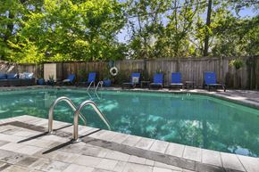 Jackson townhouse for rent - A pool with a metal ladder and a tiled edge.