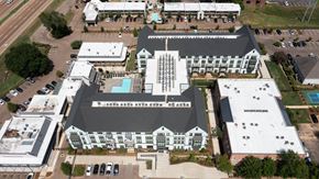 Jackson apartment for rent - An aerial view of a large building with a pool in the middle. at The Quarter Lofts Apartments, Jackson, Mississippi
