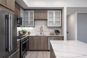 Canoga Park apartment for rent - a kitchen with stainless steel appliances and marble counter tops