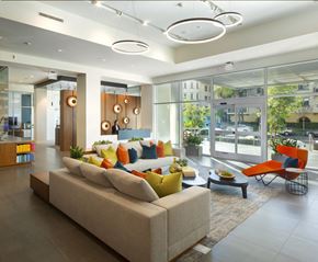Woodland Hills apartment for rent - Apartments in Woodland Hills, CA - The Q Variel - Main Lobby With 24-Hour Concierge, Comfortable Seating, Modern Designs, and Secured Fob Access Sliding Doors