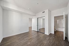 Canoga Park apartment for rent - a living room with white walls and a sliding glass door to a bathroom