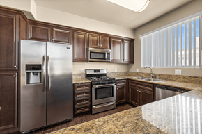 Canoga Park apartment for rent - a kitchen with stainless steel appliances and granite counter tops at Le Blanc Apartment Homes, Canoga Park, CA