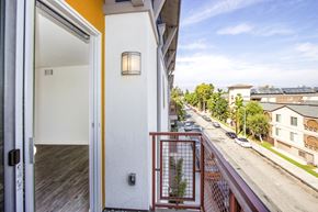 Canoga Park apartment for rent - a balcony with a view of the street and a door to a apartment building