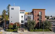 Northridge apartment for rent - A building with the word "LEGACY" on it is in front of a building with a red awning.