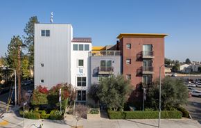 Northridge apartment for rent - A building with the word "LEGACY" on it is in front of a building with a red awning.