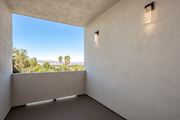 Canoga Park apartment for rent - a room with a large window and a view of palm trees