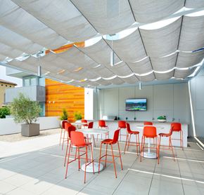 Woodland Hills apartment for rent - a dining area with red chairs and tables under a white canopy