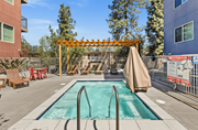 Northridge apartment for rent - A pool area with a wooden pergola and lounge chairs.