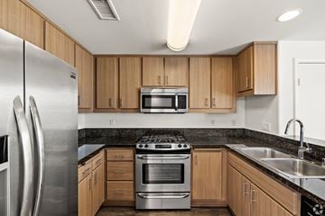 Northridge apartment for rent - A modern kitchen with wooden cabinets and stainless steel appliances.