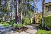 Lake Balboa apartment for rent - a sidewalk in front of a building with trees and flowers