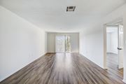 Van Nuys apartment for rent - an empty living room with white walls and wood flooring