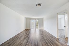 Van Nuys apartment for rent - an empty living room with white walls and wood flooring