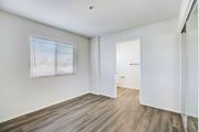 Van Nuys apartment for rent - a bedroom with white walls and wood flooring and a door to a closet