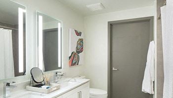 Custom light framed mirrors in bathrooms