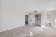 Sylmar apartment for rent - an empty living room with white walls and a bathroom at Dronfield Astoria, Sylmar, California
