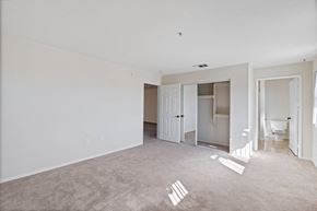 Sylmar apartment for rent - an empty living room with white walls and a bathroom at Dronfield Astoria, Sylmar, California