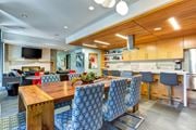 Seattle apartment for rent - A modern kitchen with a wooden table and chairs in the Aperture clubhouse