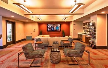 Phoenix apartment for rent - a living room with a couch and chairs and a television
