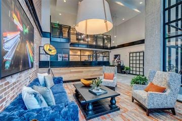 Seattle apartment for rent - A living room with a blue couch and a grey armchair.