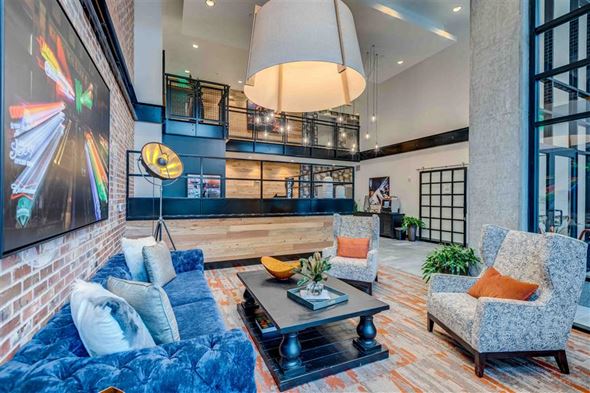 Seattle apartment for rent - A living room with a blue couch and a grey armchair.
