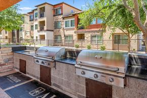 Peoria apartment for rent - A row of outdoor BBQs are lined up on a brick wall.