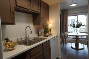 Sun City apartment for rent - A kitchen with brown cabinets and a white countertop.