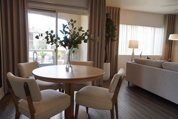 Sun City apartment for rent - A living room with a round table and chairs.