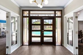 Houston apartment for rent - a view of a pool from a hallway with glass doors