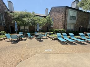 Carrollton apartment for rent - A sunny day at the pool with chairs and umbrellas.