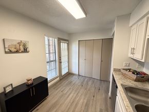 Carrollton apartment for rent - A kitchen with a black cabinet and a framed picture on the wall.