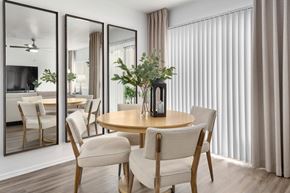 Sun City apartment for rent - A modern dining room with a round table and chairs.