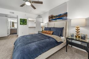 Sun City apartment for rent - A bedroom with a large bed and a ceiling fan.