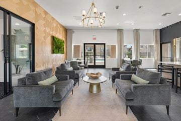 Tucson apartment for rent - A living room with grey couches and a chandelier.