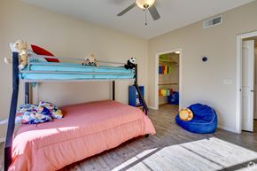 Tucson apartment for rent - A bedroom with a blue bunk bed and a pink bedspread.