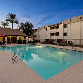 Phoenix apartment for rent - A swimming pool in a resort with a building in the background.